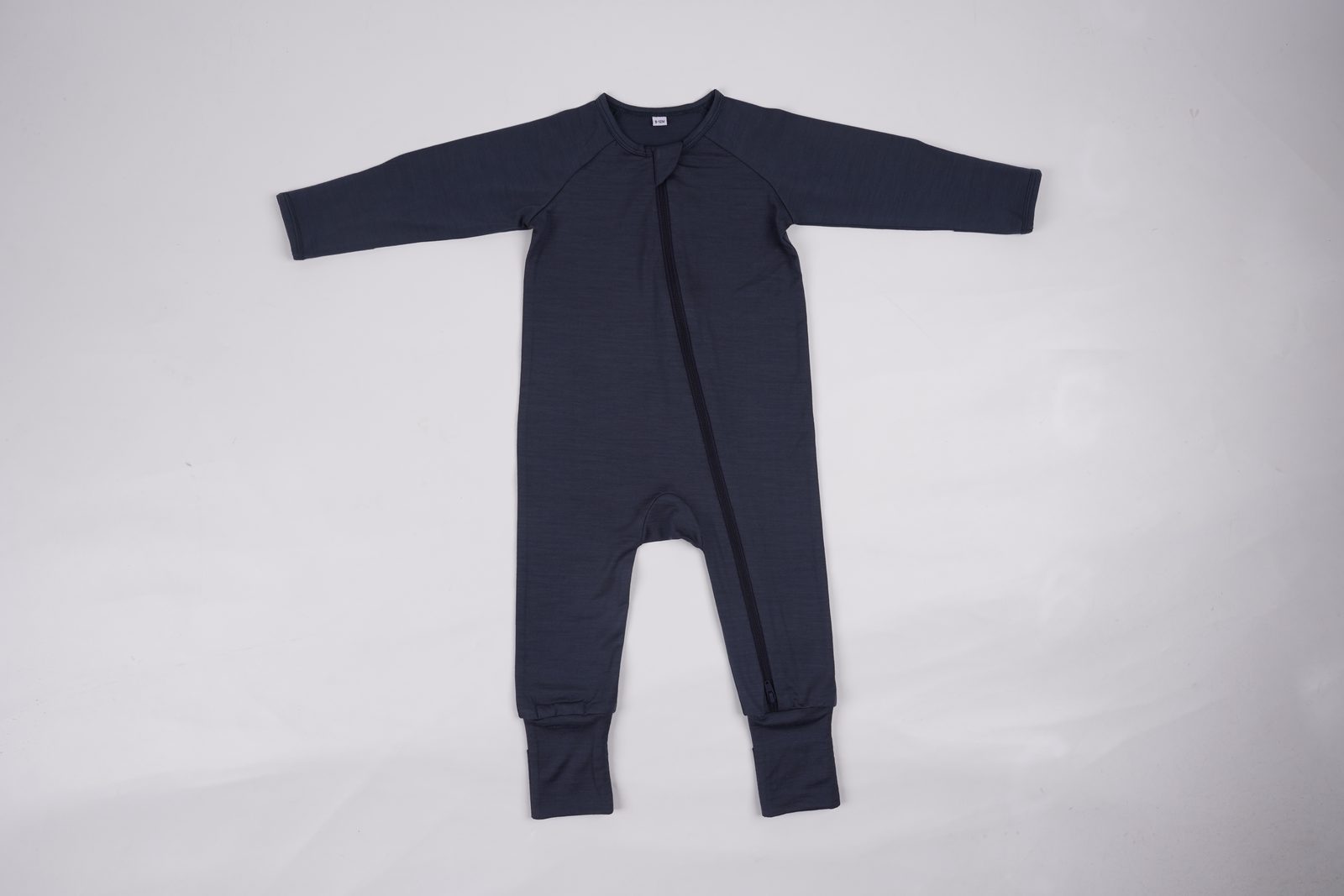 Knit baby sleep suit laid flat — real production sample photo